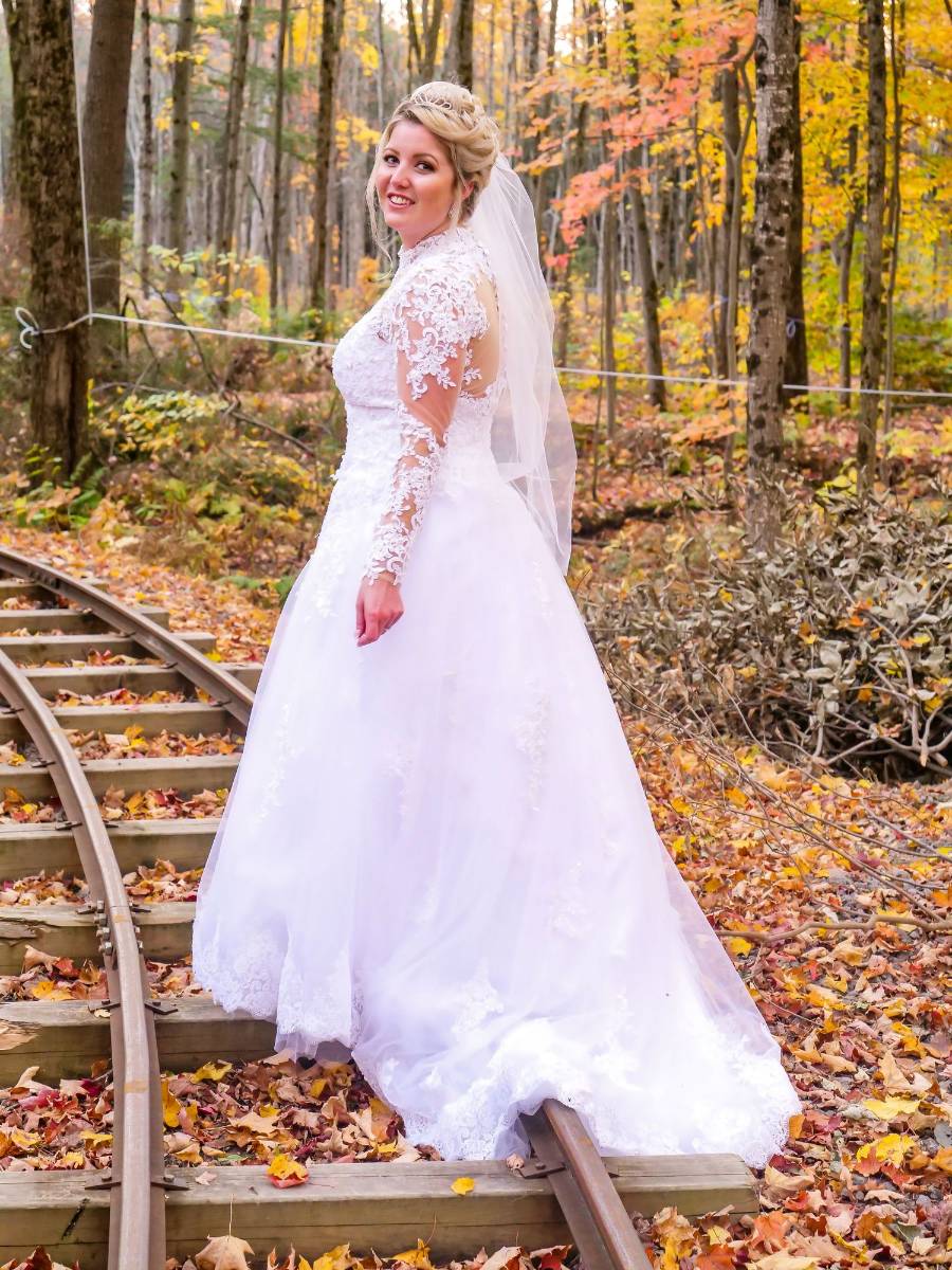 Bride on autumn railway tracks
