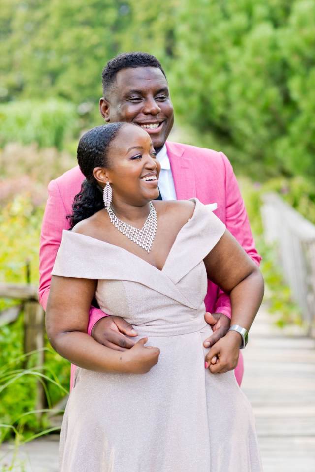 Couple embracing on a garden bridge